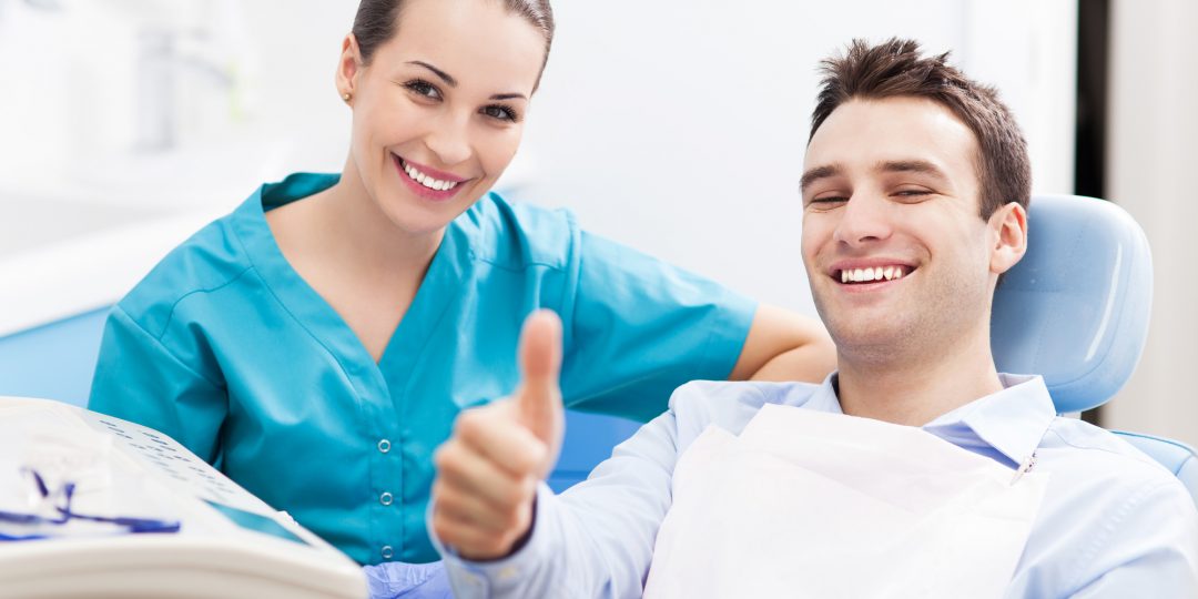 Dentist and Patient in a Dental Chair Smiling